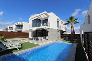 a house with a swimming pool in front of it at Vistabella in Orihuela