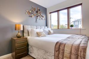 a bedroom with a large bed and a window at Mica Point City Centre Apartment in Birmingham
