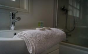 a white towel on the edge of a bathroom sink at The City Walls Gathering in Chester