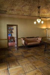 a living room with a couch and a mirror at Albergo Italia in Varallo