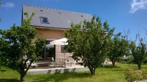 a house with a table and chairs and trees at Entre Paimpol et Bréhat ! in Ploubazlanec