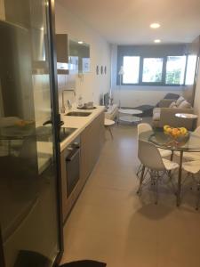 a kitchen and living room with a table and a couch at Mapagadi in Arucas