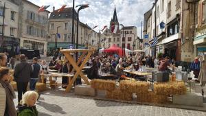 a crowd of people sitting at tables in a street at Fast Hotel Brie-Comte-Robert in Brie-Comte-Robert