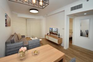 a living room with a couch and a table at Boutique Lake Kinneret Apartment in Tiberias