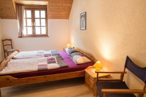 a bedroom with a wooden bed and a window at Ferienhaus Marie in Bremm