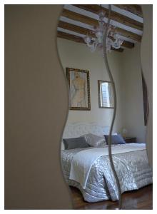 a bedroom with a bed and a large mirror at Domus Dea in Venice