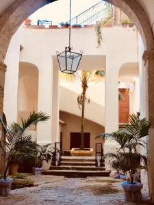 a staircase leading up to a balcony with a clock on it at S'O Smart B&B Tropea in Tropea