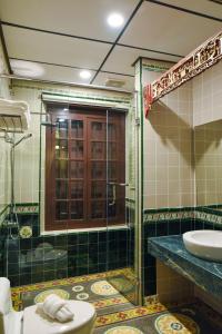 a bathroom with a shower and a toilet and a sink at 5 Heeren Museum Residence in Melaka +52 photos