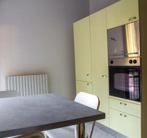 a kitchen with a table and a microwave at Il covo di Gio' apartament in Modena