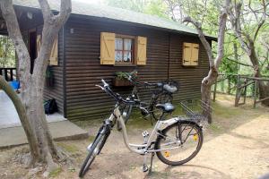 a bicycle parked in front of a cabin at Caravelle Camping Village in Ceriale