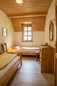 a bedroom with two beds and a window at Ferienhaus Marie in Bremm +15 photos