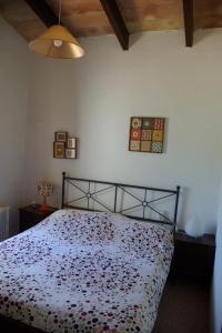 a bedroom with a bed with a floral bedspread at Houpla Sol in Manacor +18 photos