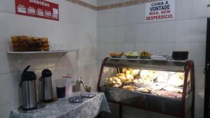 a restaurant with a buffet of food on a table at Hotel Santa Rita in Aparecida