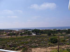 a view of the ocean from a hill at Blue Beach Villas Apartments in Stavros