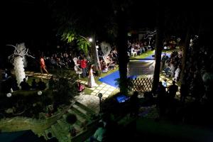 a crowd of people sitting around a park at night at Villa Martina in Fermignano