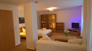 a hotel room with a bed and a couch at Ferienwohnung Markt 7 in Mücheln