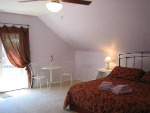 a bedroom with a bed and a table and chairs at Ahoy Inn Guesthouse in Put-in-Bay
