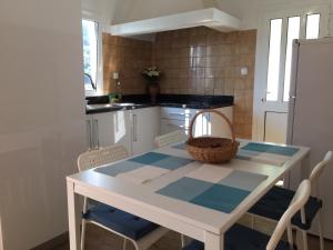 a kitchen with a table with a basket on it at Casinha da Vila in Arcos de Valdevez +12 photos