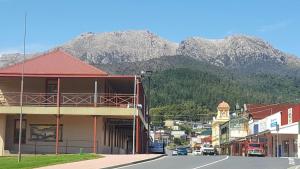 a town with a mountain in the background at Mt Lyell Motor Inn - By Orangepete in Queenstown +6 photos