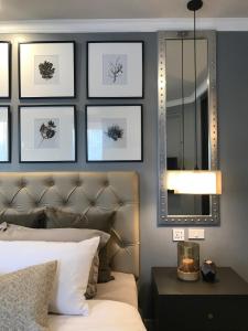 a bedroom with a bed and a mirror at Stay in Style at Nimman R306AB in Chiang Mai
