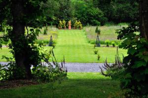 a garden with a path in the middle of a field at Penbontbren Luxury Bed and Breakfast in Aberporth
