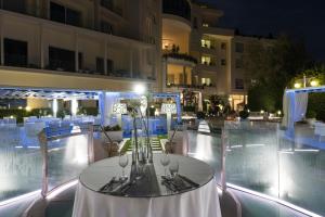 a table with wine glasses on top of a building at Grand Hotel Biffy in Ariano Irpino