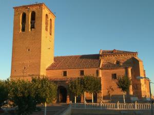 a large brick building with a clock tower at Casa Rural Isabel in Villaflores