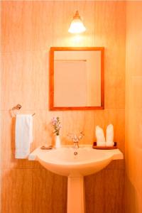 a bathroom with a white sink and a mirror at Teanest Nightingale by Nature Resorts in Kotagiri