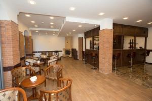 a restaurant with tables and chairs in a room at Faria Boutique Hotel in Tsaghkadzor
