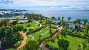 an aerial view of a park with palm trees and the ocean at Hipotels Natura Palace Adults Only in Playa Blanca