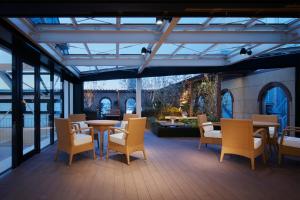 a patio with chairs and a table and a table and chairs at Garden Hotel Shizuoka in Shizuoka