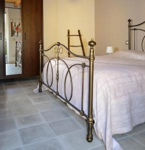 a bedroom with a bed and a tiled floor at Casina dello Zio in Verbania