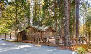 a log cabin in the middle of a forest at 50R Soots-Me in Wawona