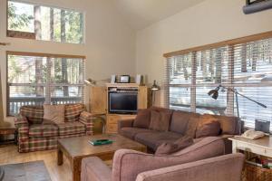 a living room with a couch and a tv at 7S Wawona Chalet in Wawona