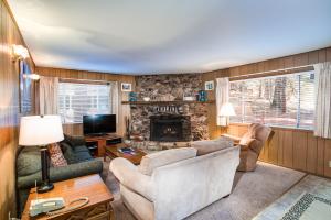 a living room with a couch and a fireplace at 9B Deer Hollow in Wawona