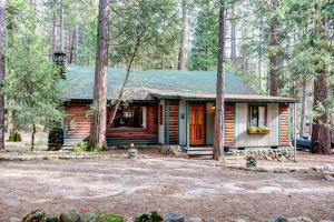 a log cabin in the middle of a forest at 57 The Williams Cabin in Wawona