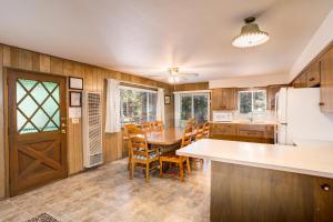 a kitchen and dining room with a table and chairs at 9B Deer Hollow in Wawona
