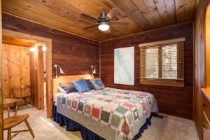 a bedroom with a bed and a ceiling fan at 53 Creekside Cabin in Wawona
