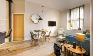 a living room with a table and a couch at No 1, Midland Bank Chambers in Ambleside