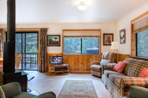 a living room with a couch and a stove at 1S Cecils Cabin in South Wawona