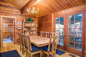 a dining room with a wooden table and chairs at 41A Cedar Chalet in Wawona