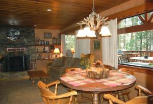 a living room with a table and a couch at 26 Deer Den in North Wawona