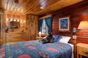 a dog sitting on a bed in a bedroom at 51 Mia Mora in Wawona