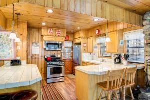 a kitchen with wooden cabinets and a stove top oven at 7 Cedar Lodge in Wawona