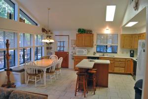 a kitchen and dining room with a table and chairs at 23A Big Cedar in Wawona