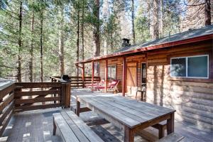 a wooden deck of a cabin in the woods at 70 Simmons Den in Wawona