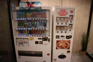 a refrigerator filled with lots of different types of drinks at Khaosan World Tennoji in Osaka