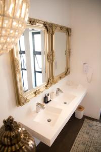 a bathroom with a white sink and a mirror at The Rez Guesthouse in Walvis Bay +88 photos