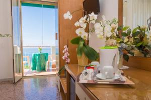 a kitchen with a counter with flowers on it at Hotel Baia Verde in Maiori