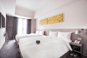 Letto o letti in una camera di CityInn Hotel Plus- Fuxing North Road Branch